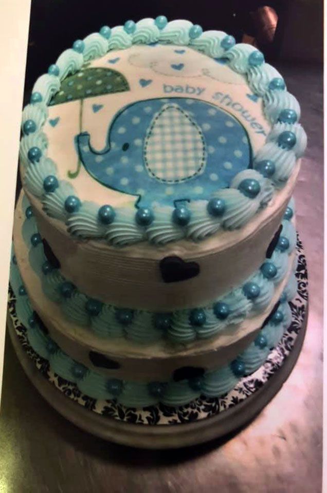 A baby shower cake with a picture of an elephant on it