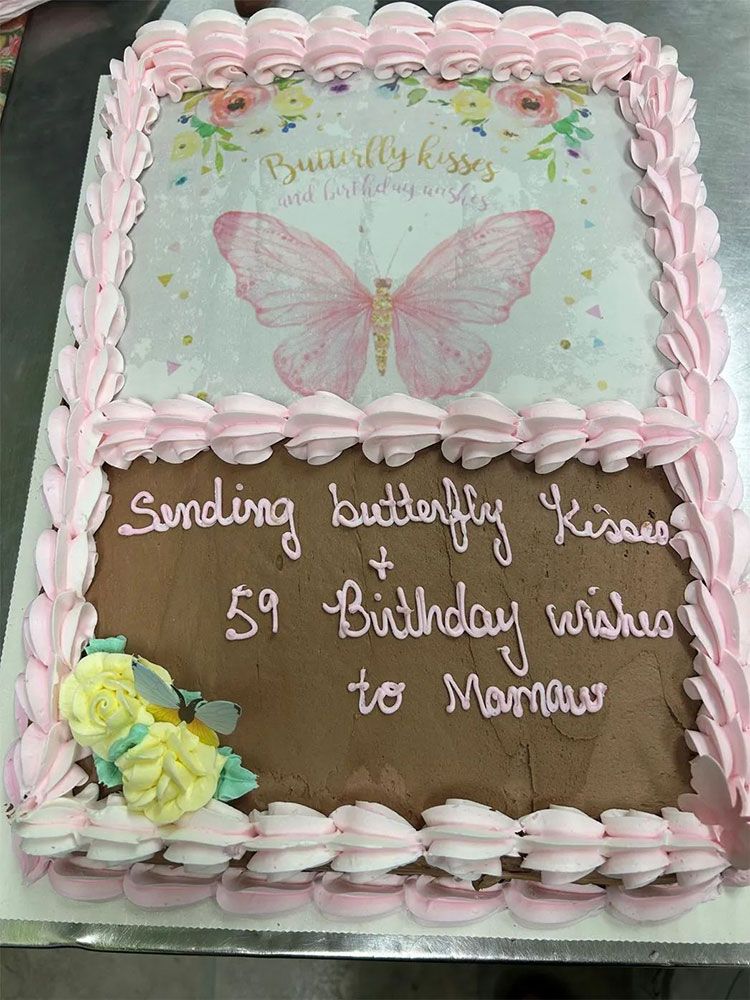 A birthday cake with a picture of a butterfly on it.