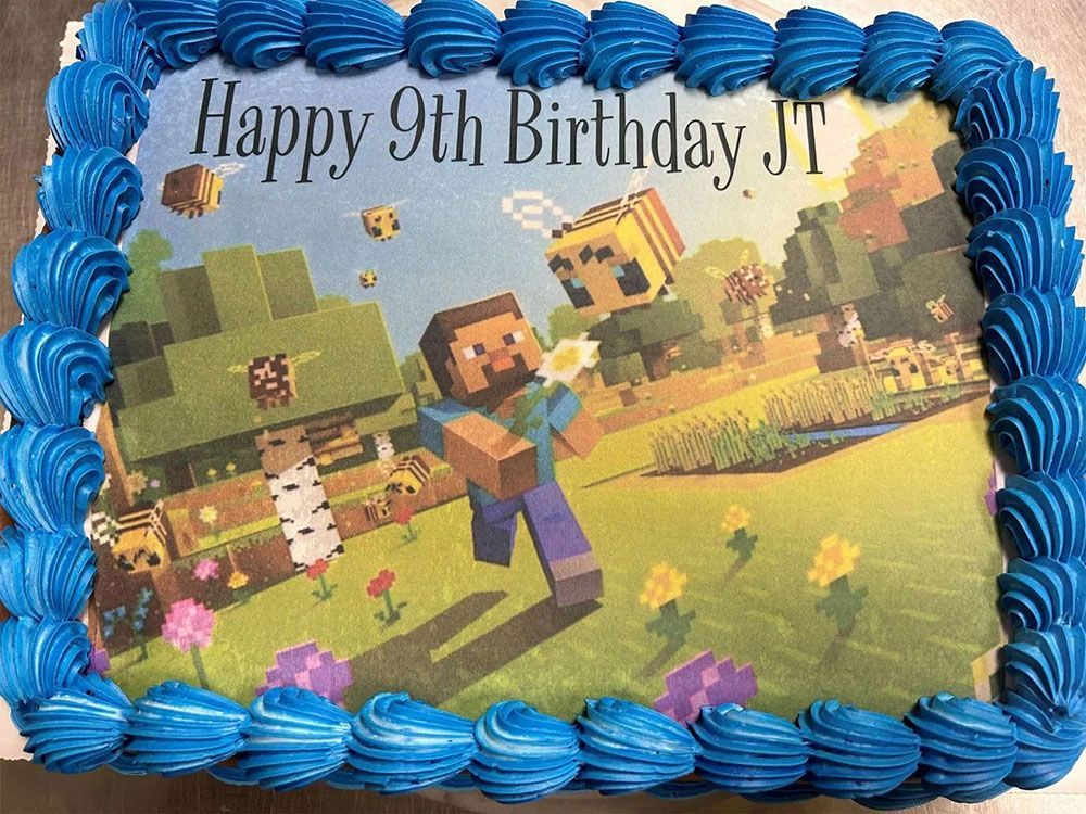 A birthday cake with a picture of minecraft on it.