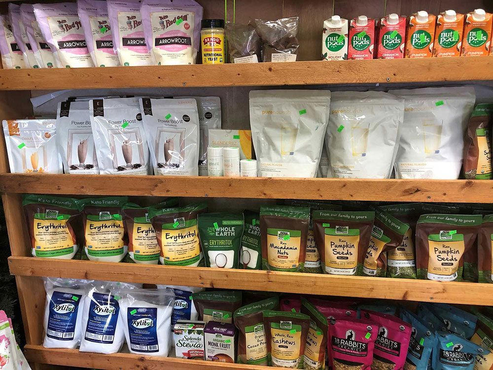 A wooden shelf filled with bags of food and drinks.