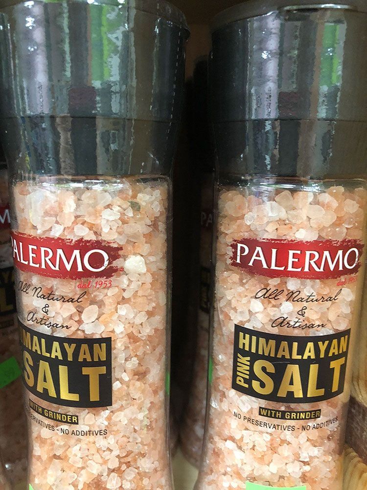 Two bottles of palermo pink himalayan salt are sitting next to each other on a shelf.