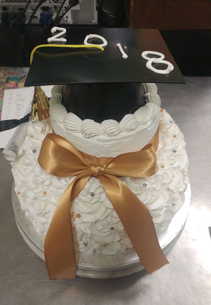 A cake with a graduation cap on top of it.
