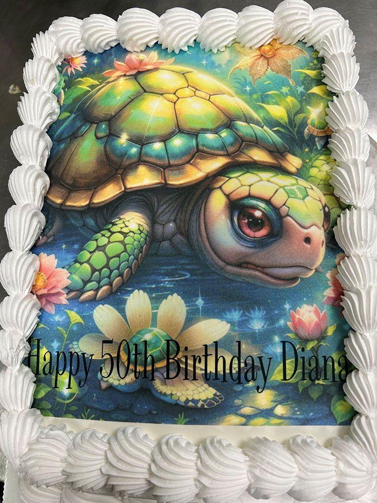 A birthday cake with a picture of a turtle on it