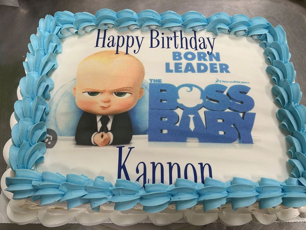 A birthday cake with a picture of the boss baby on it