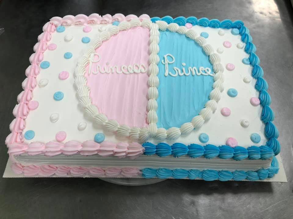 A pink and blue cake with the words princess and prince on it