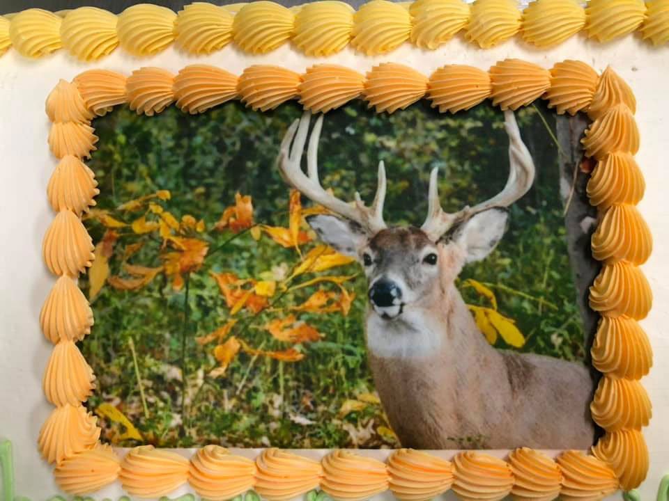 A cake with a picture of a deer on it