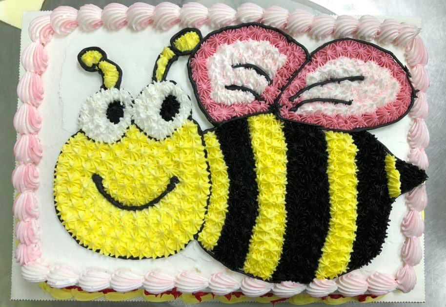 A birthday cake with a bee on it