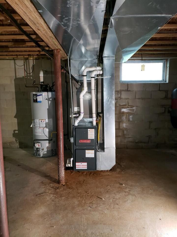 A basement with a water heater and a furnace.