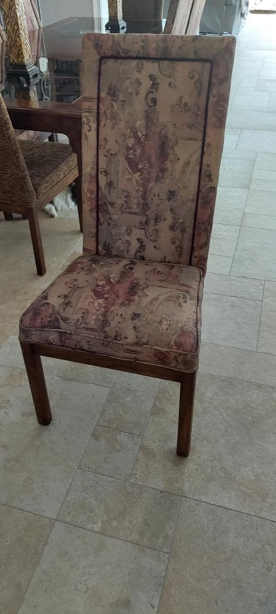 A dining chair with a patterned seat and back, in a room with tiled flooring.