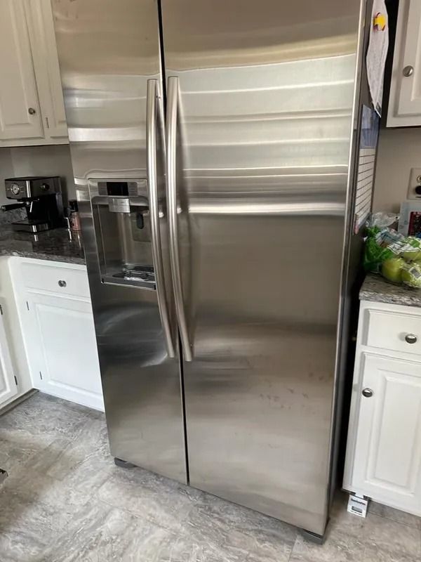 Stainless steel French door refrigerator in a white kitchen