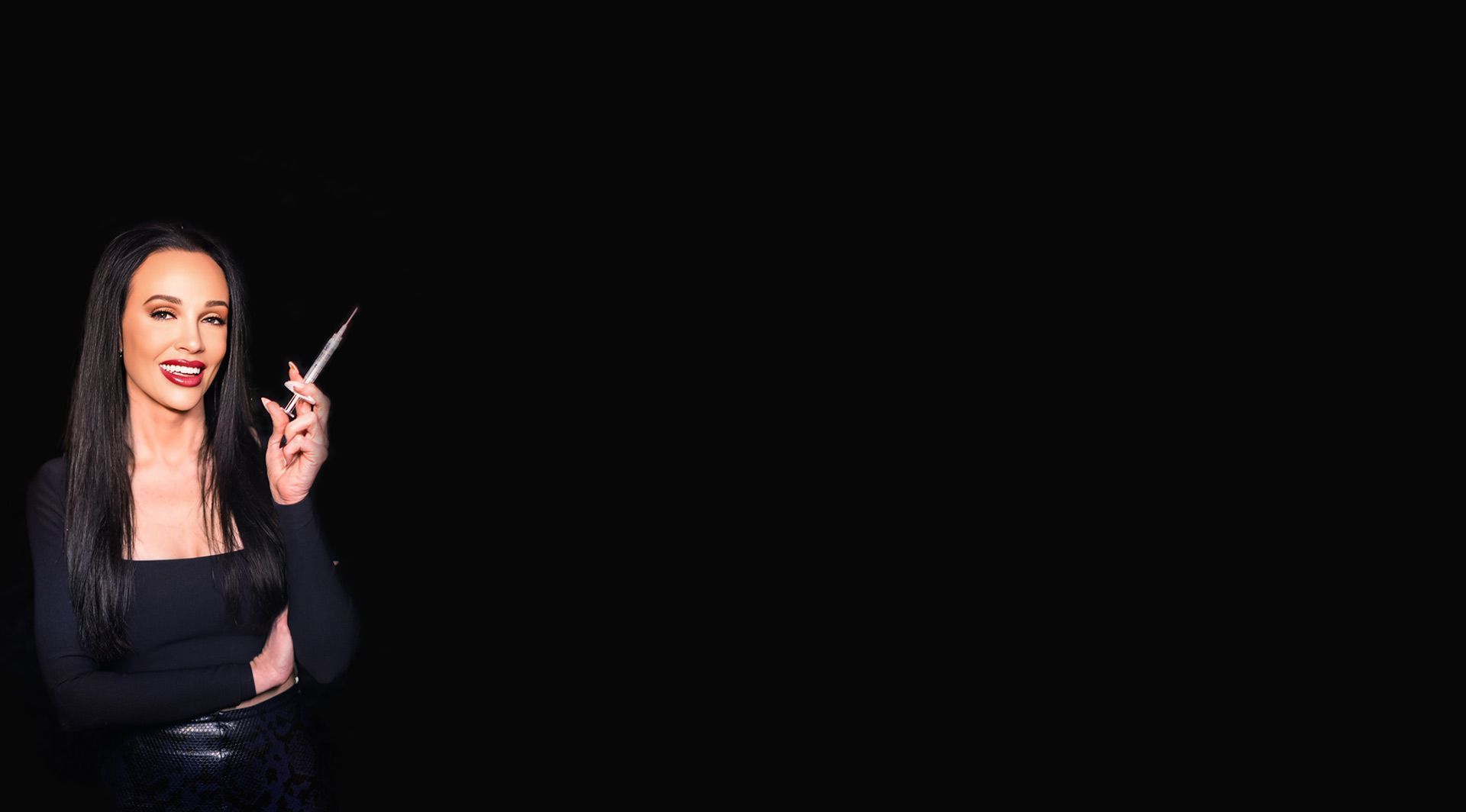 A woman is holding a pair of scissors in her hand.
