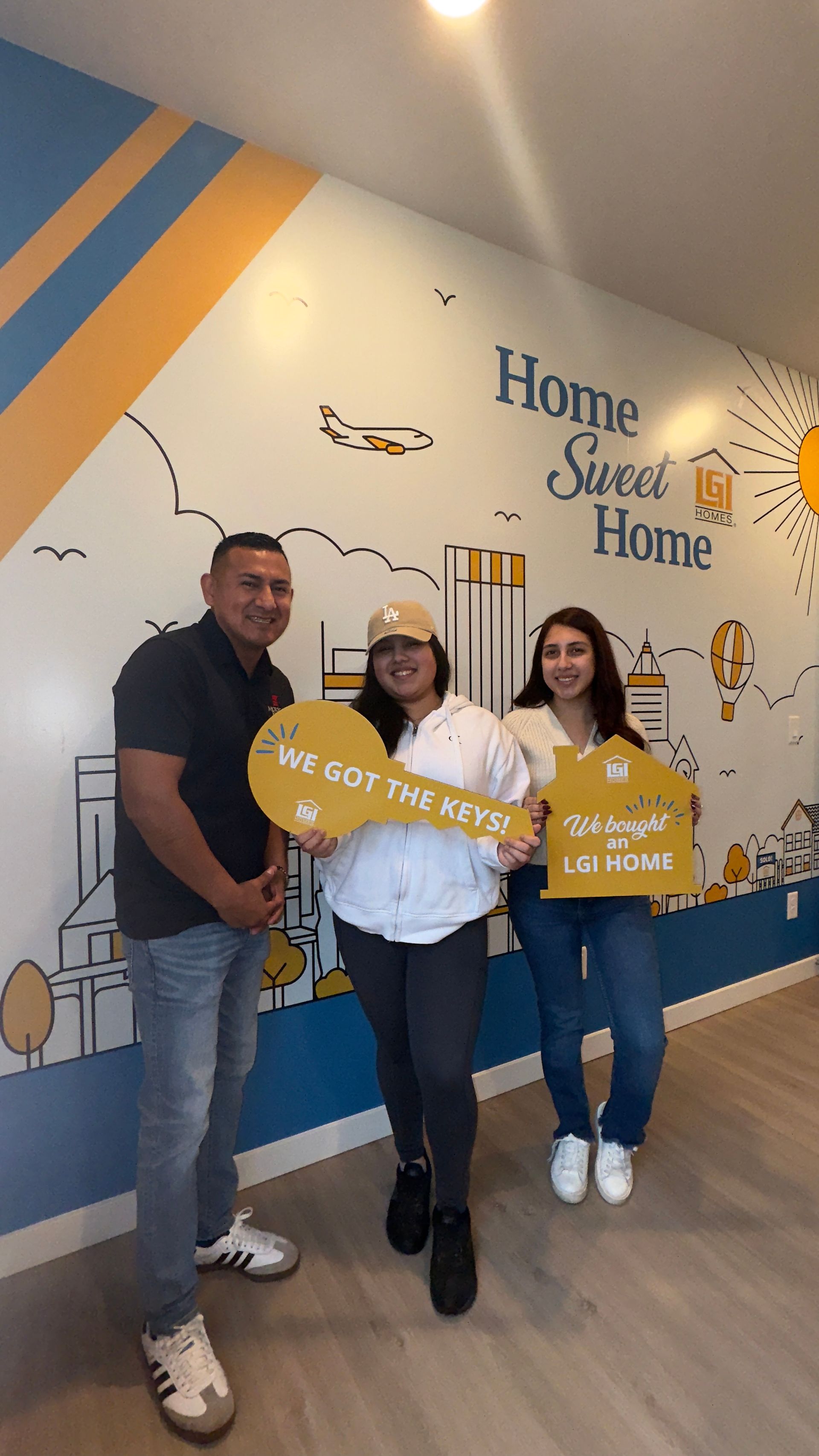 A group of people standing next to each other holding a sign