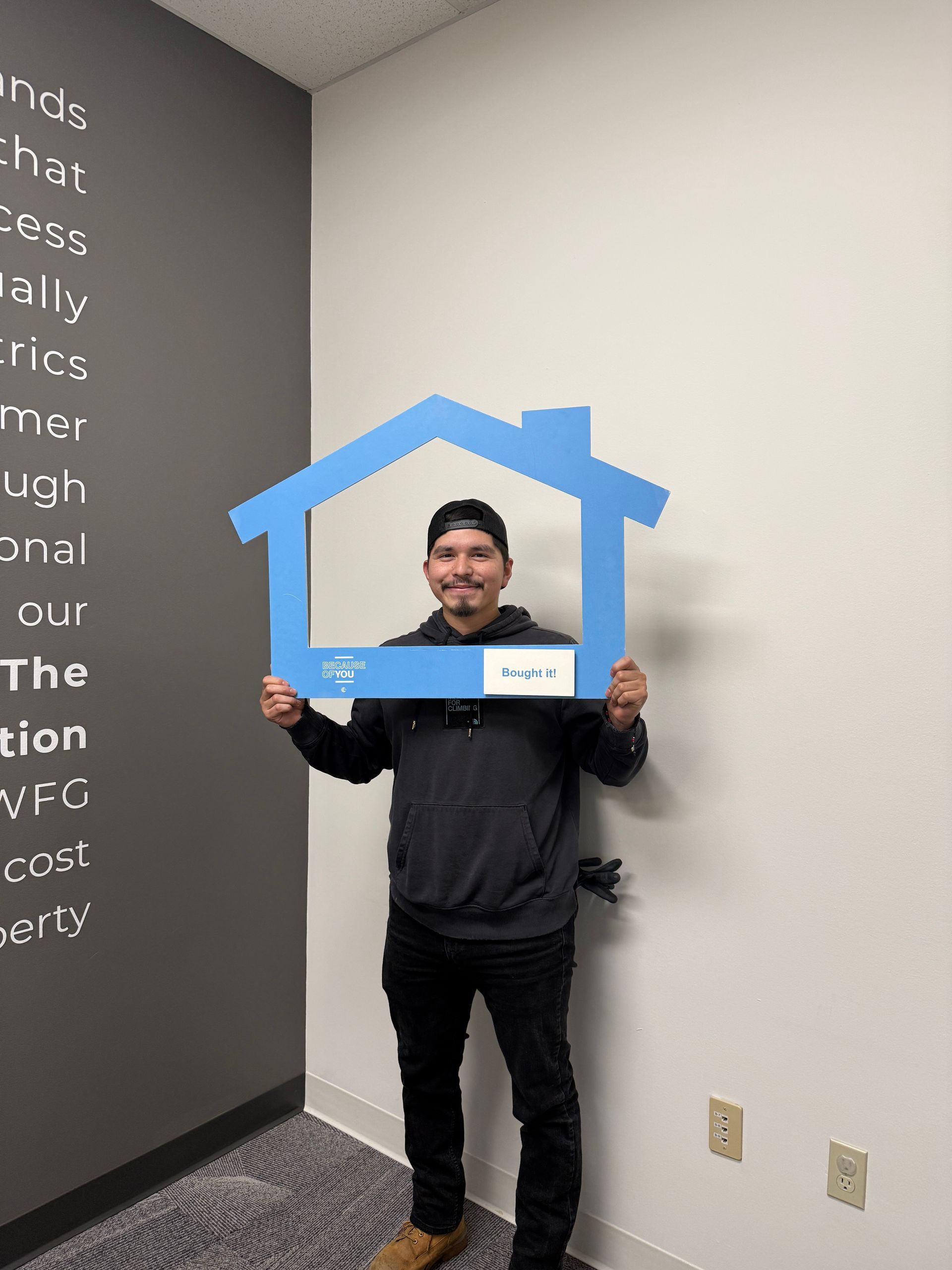 Man holding house-shaped frame around his head