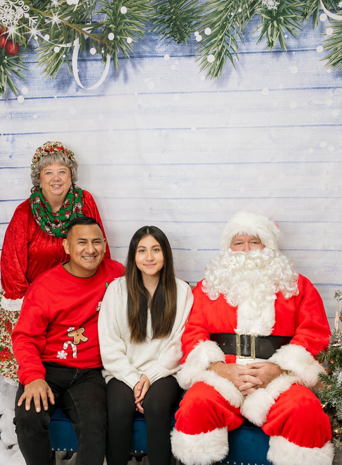 A family is posing for a picture with santa claus.