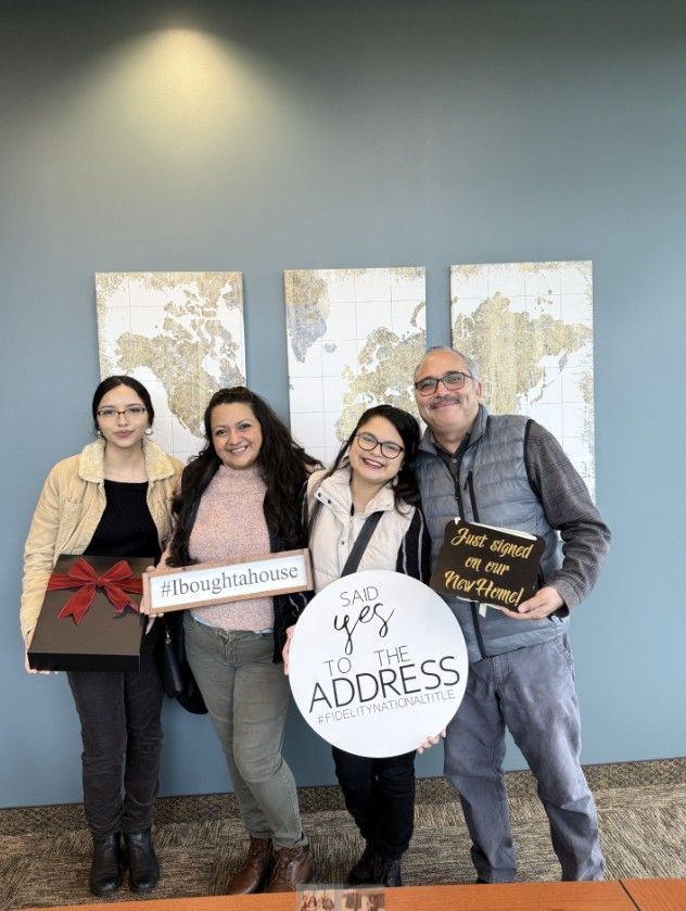 A group of people standing next to each other holding signs.