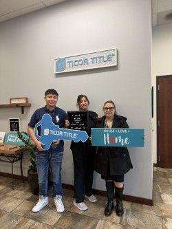A group of people standing next to each other holding signs.