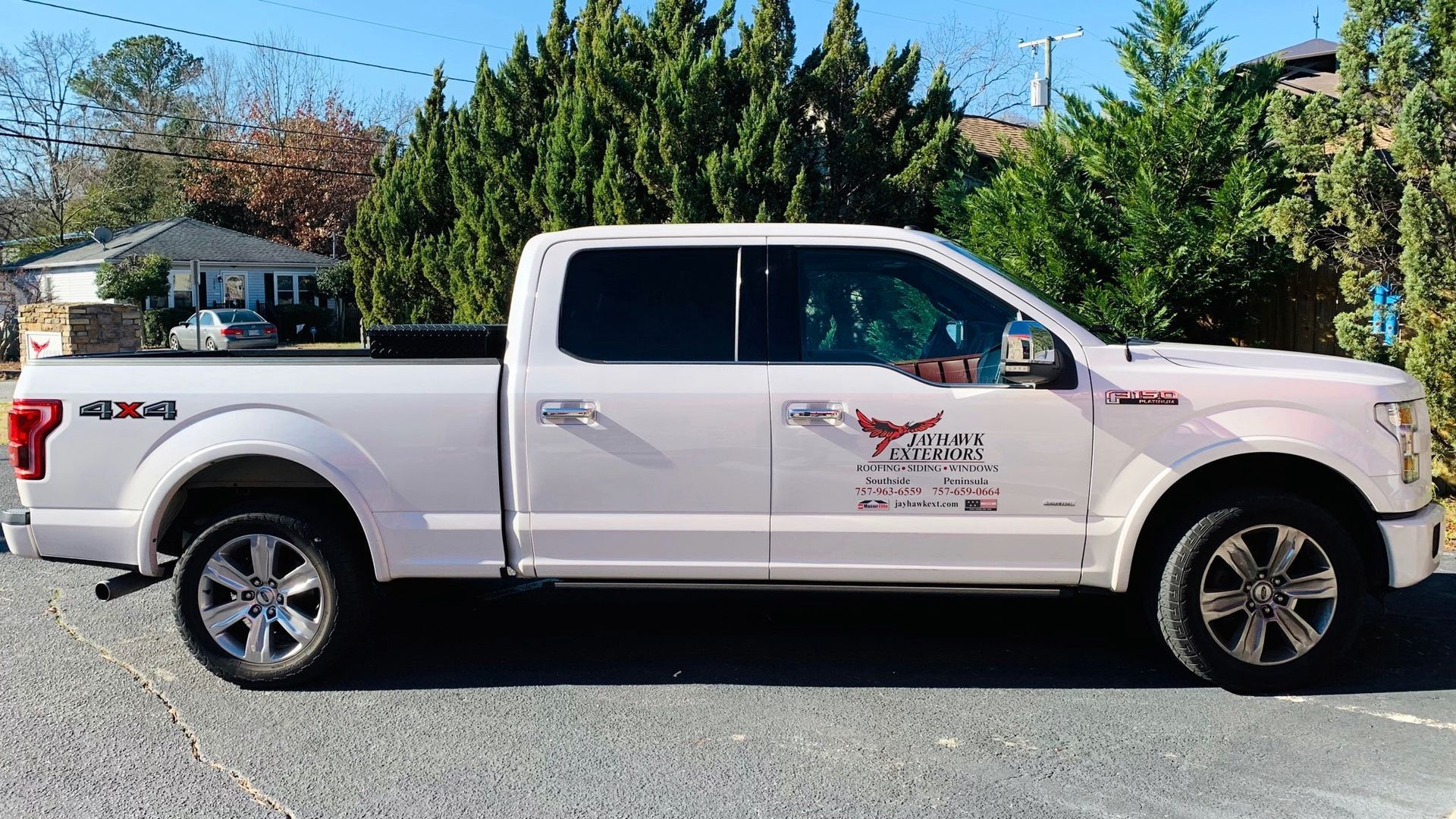 A white pickup truck is parked in a parking lot.