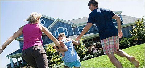 Happy family infront of a home