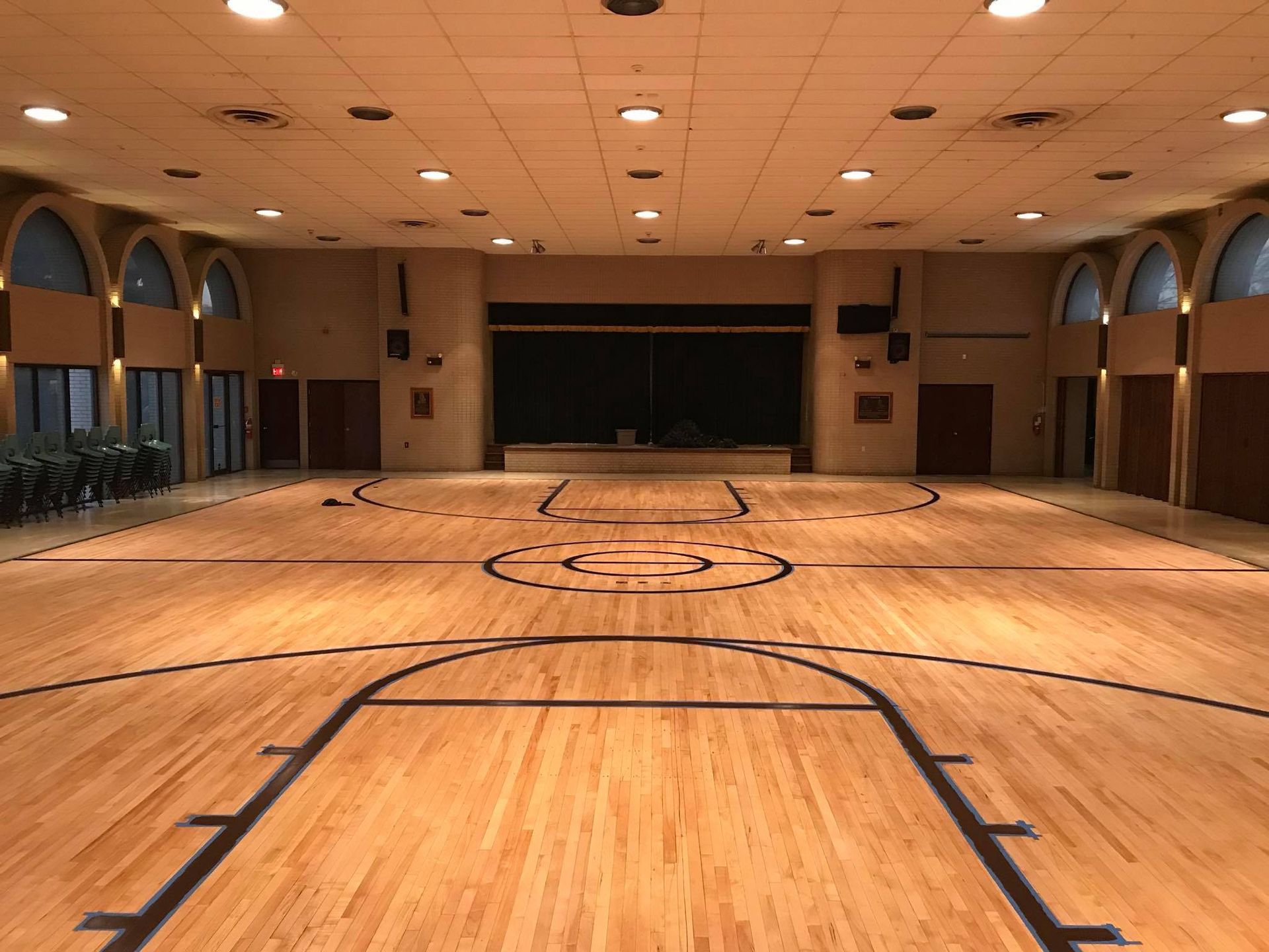 An empty basketball court with a wooden floor
