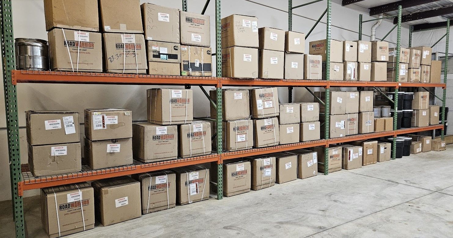 Warehouse shelving units filled with rows of stacked cardboard shipping boxes on multiple levels.