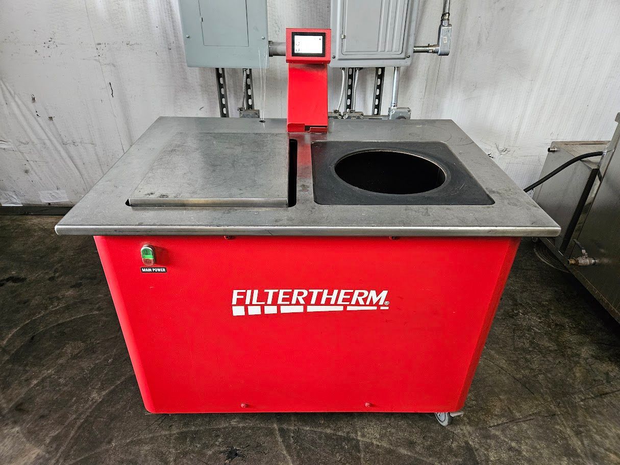 A red Filtertherm industrial filtration machine with a stainless steel top, digital screen, and a circular opening.