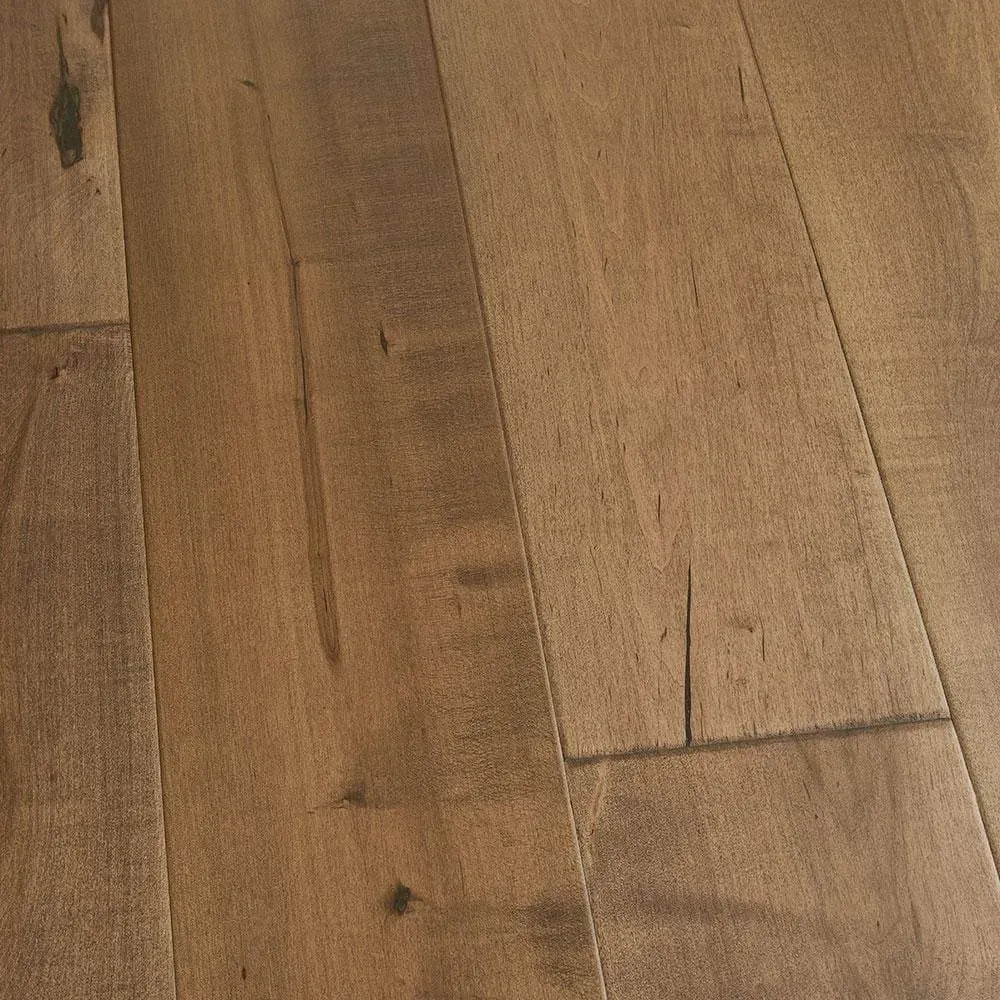 A close up of a wooden floor in a room.