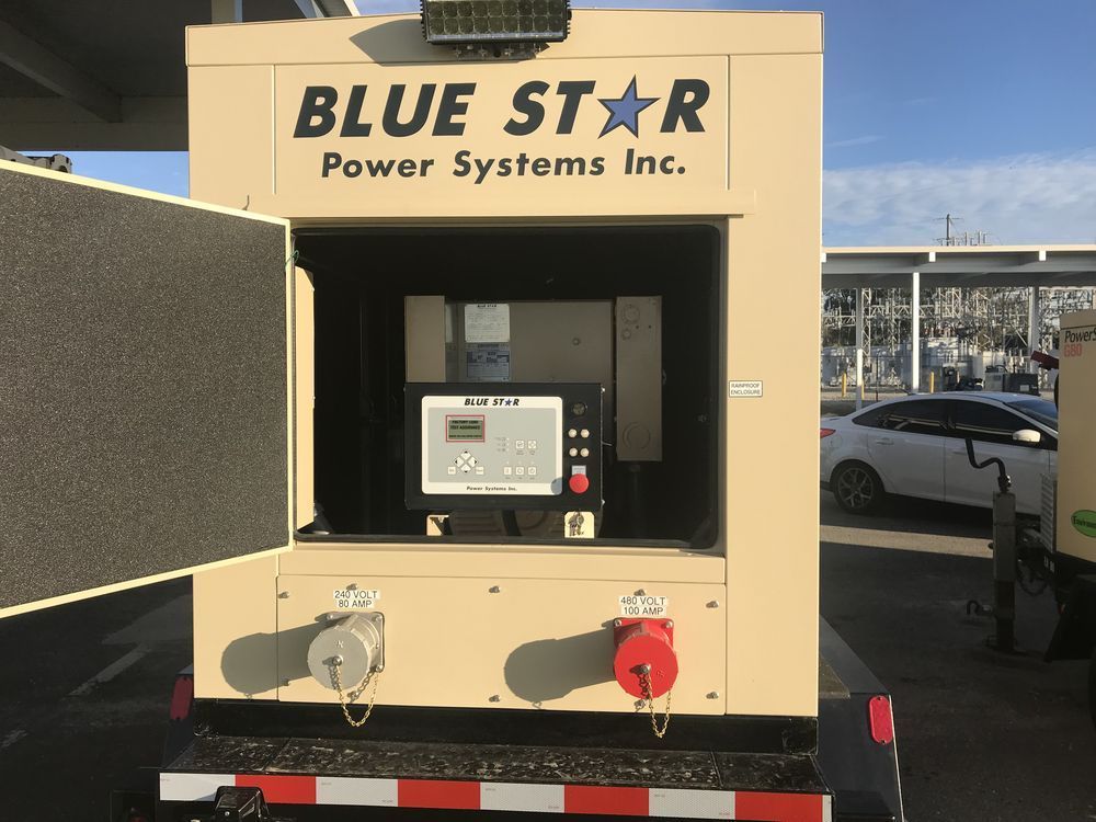 Blue Star Power Systems generator with control panel, shown outdoors at a dealership or lot.