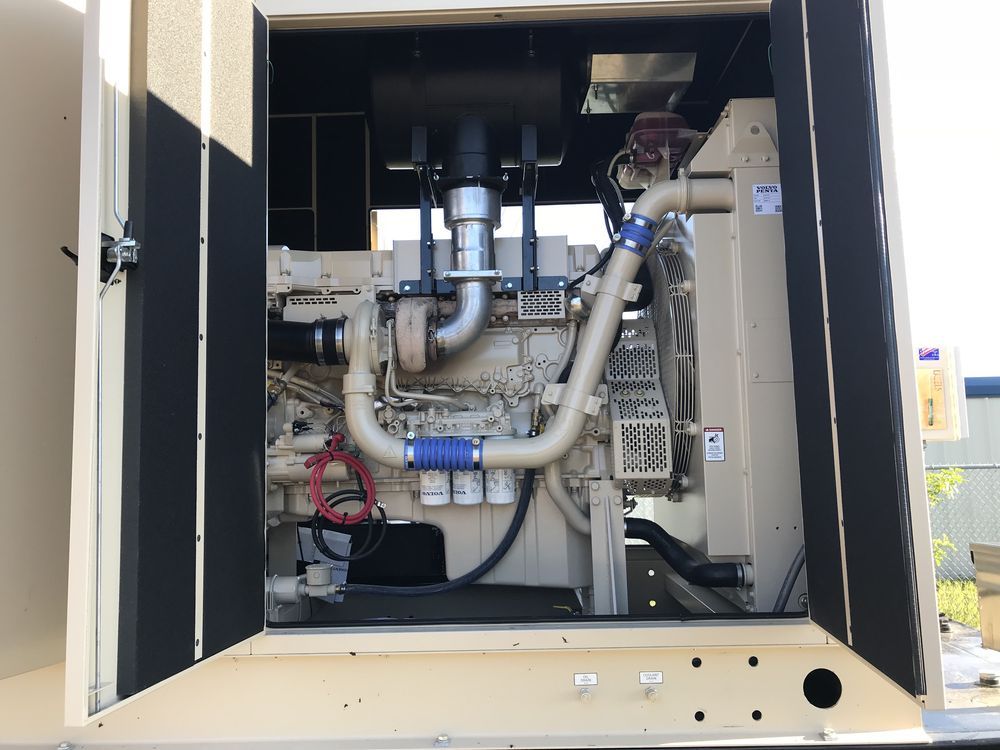 Open utility cabinet with pipes, hoses, and mechanical equipment inside.