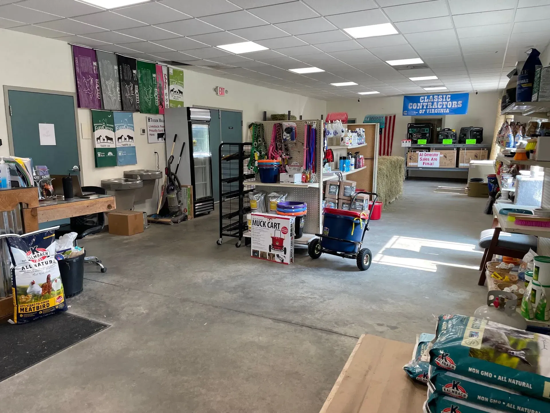 Interior of a store with pet supplies, featuring shelves and products; gray floor, bright lighting.