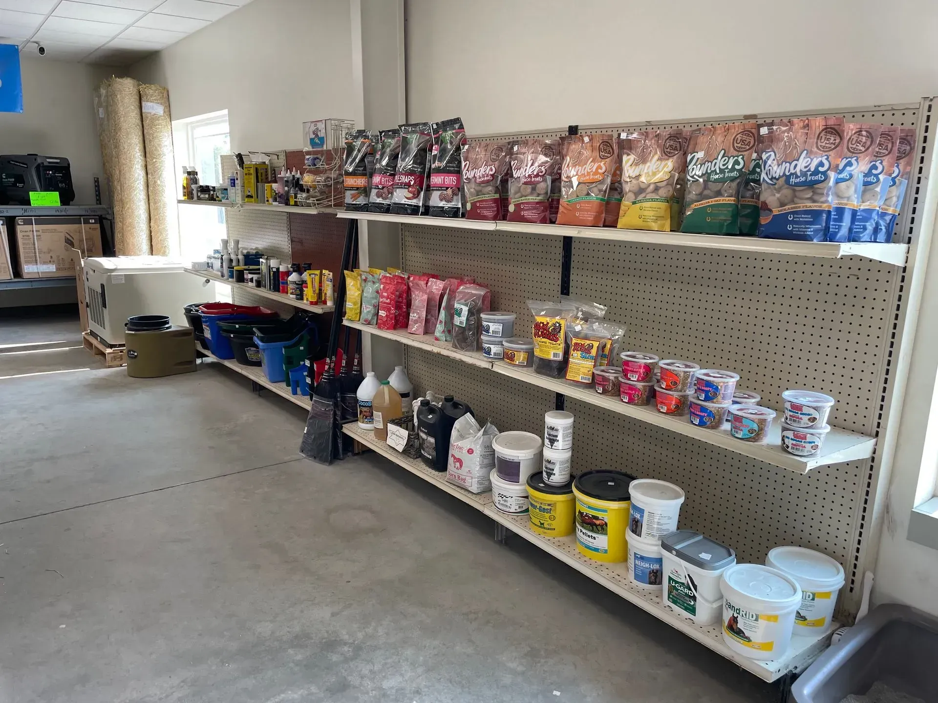 Shelves stocked with various pet food and supplies in a store.