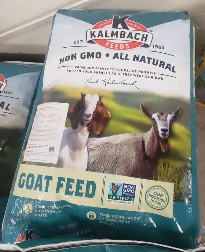 Bag of Kalmbach Goat Feed, Non-GMO, with images of goats on the front. Green and white packaging.