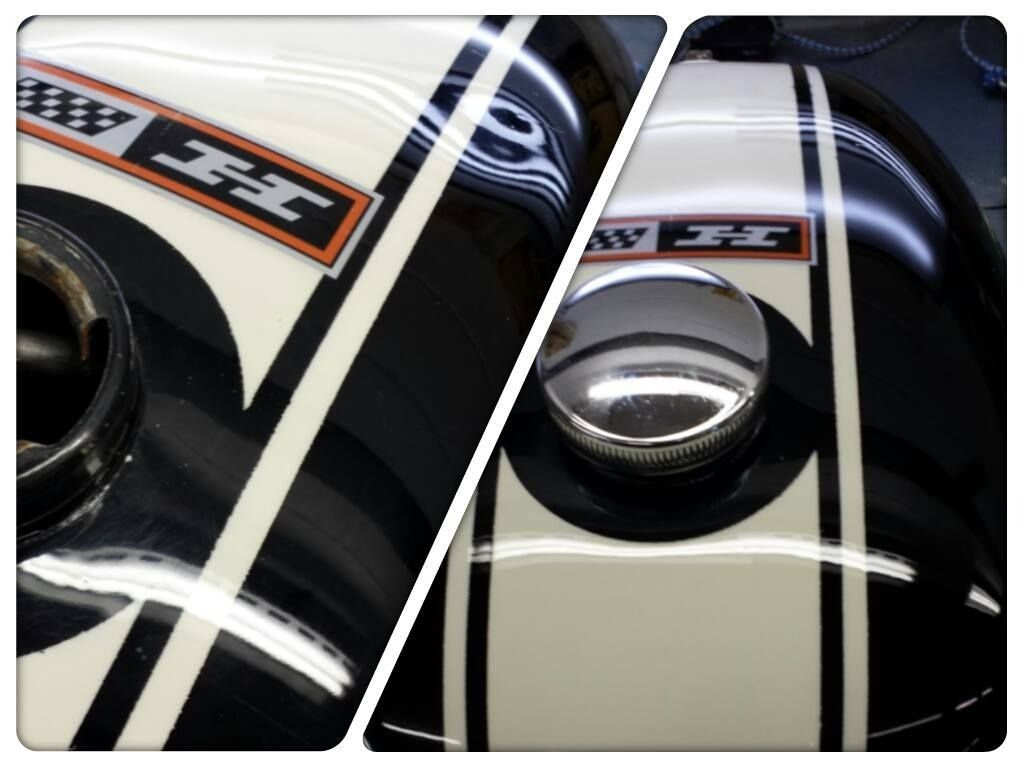 Close-up of a glossy black classic car hood with white racing stripes and a side mirror.