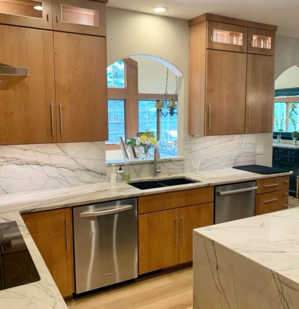 A kitchen with stainless steel appliances and wooden cabinets