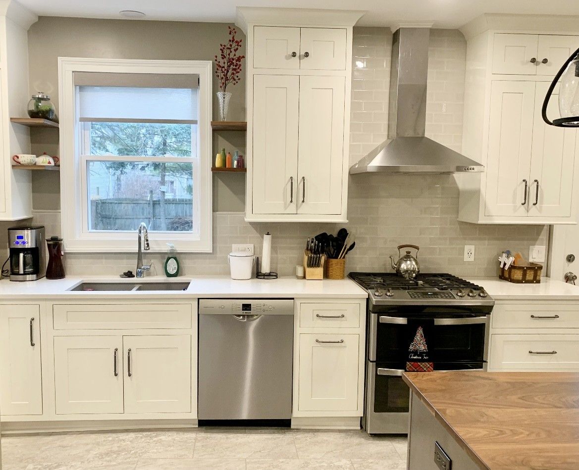 A kitchen with white cabinets and stainless steel appliances.