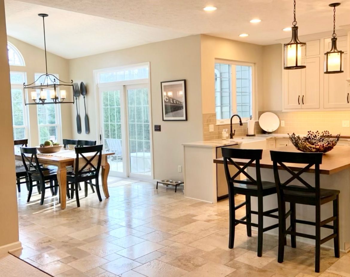 A kitchen with a table and chairs in it