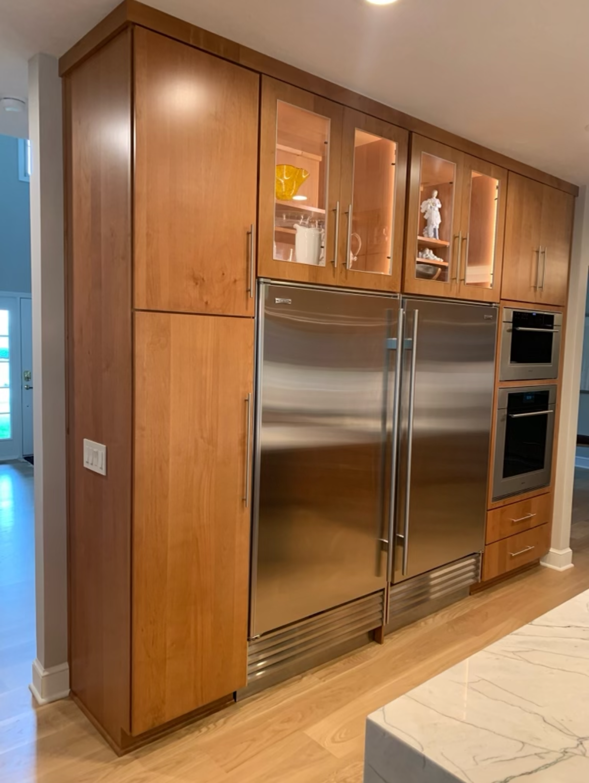 A kitchen with stainless steel appliances and wooden cabinets