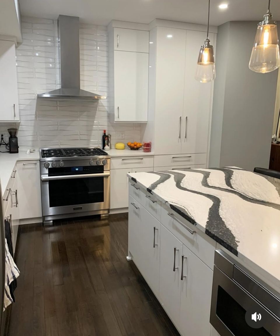 A kitchen with white cabinets and stainless steel appliances