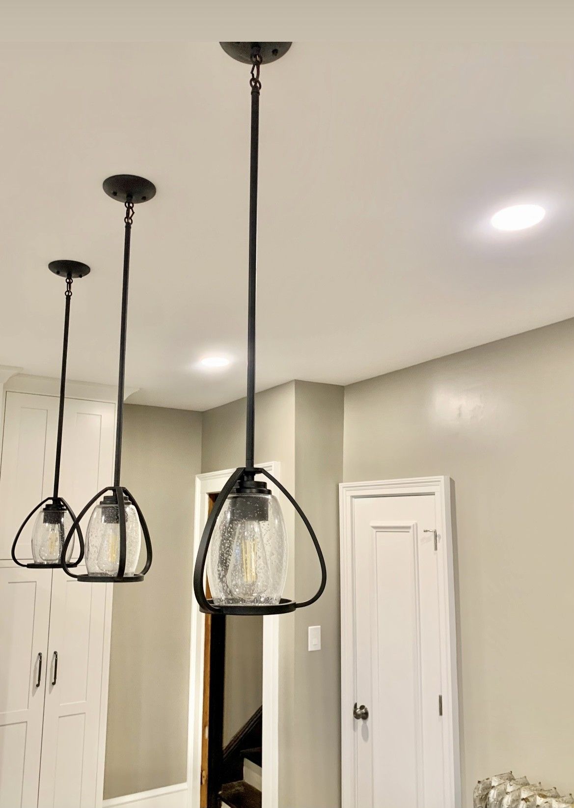 Three pendant lights are hanging from the ceiling in a room.