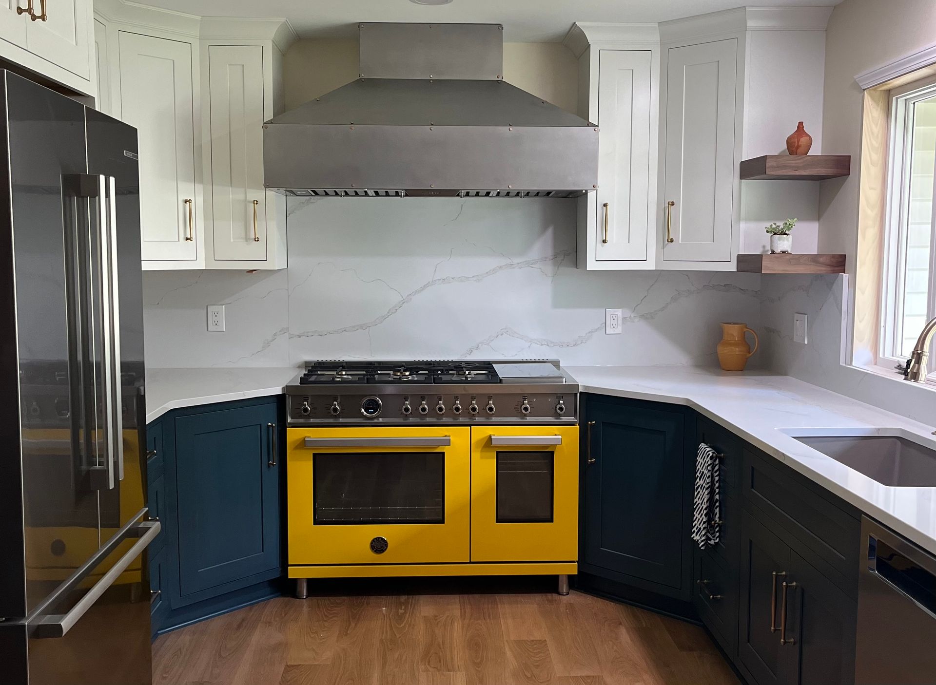 A kitchen with a yellow stove and a black refrigerator