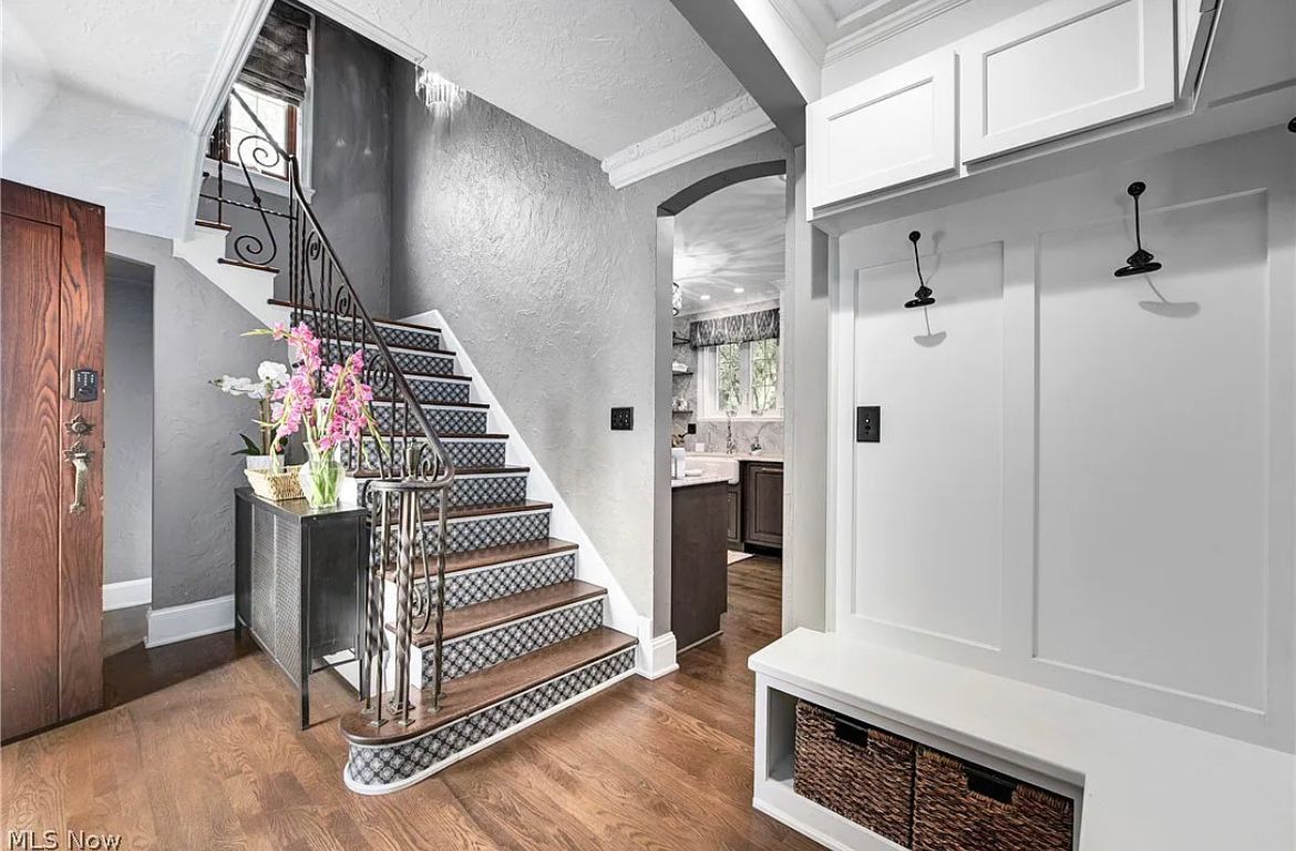 A hallway with stairs leading up to the second floor of a house.