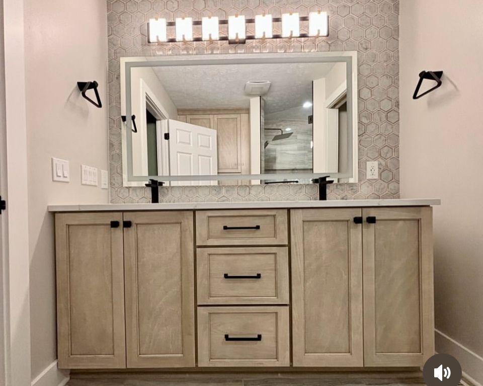 A bathroom with two sinks and a large mirror.