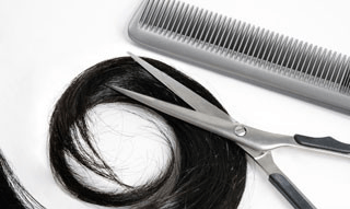 Black hair, scissors and comb
