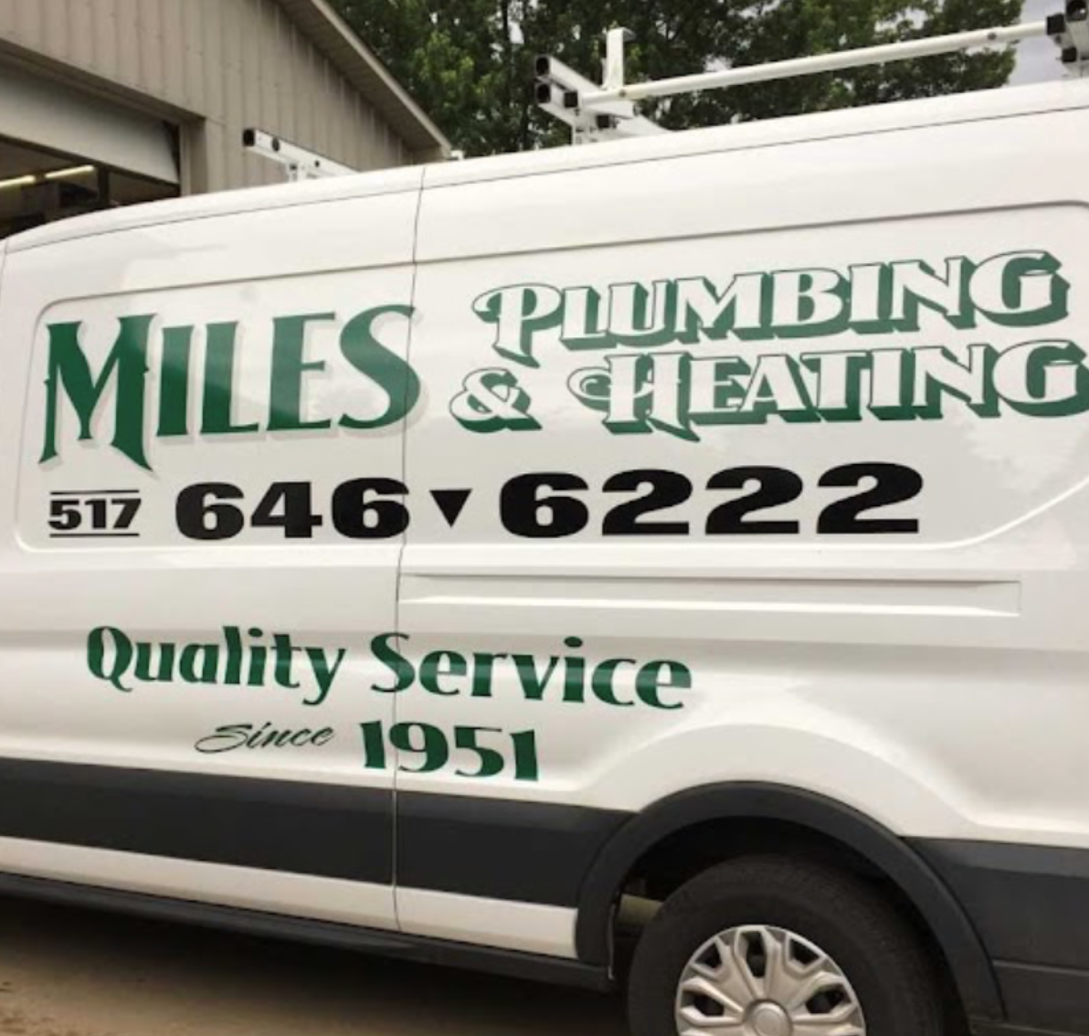A white van that says miles plumbing & heating quality service