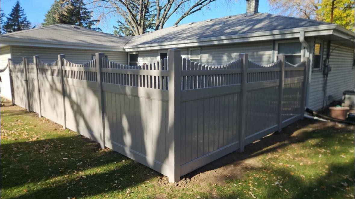 White fenced patio enclosure attached to a house in a sunny backyard