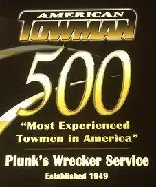 American Towman 500 poster with gold text: “Most Experienced Towmen in America” and Plunk’s Wrecker Service Est. 1949