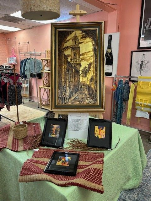 A painting is on display on a table in a store.