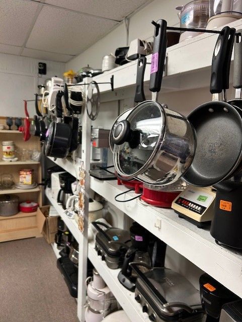 A row of shelves filled with pots and pans