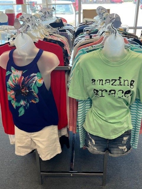 A green shirt that says amazing breeze is on a mannequin