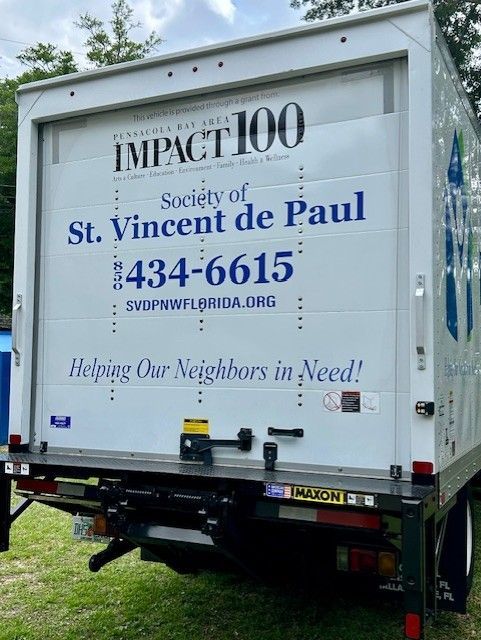 A white truck that says impact 100 on the back