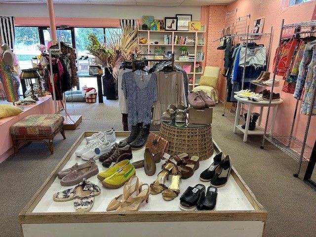 A table full of shoes and clothes in a store